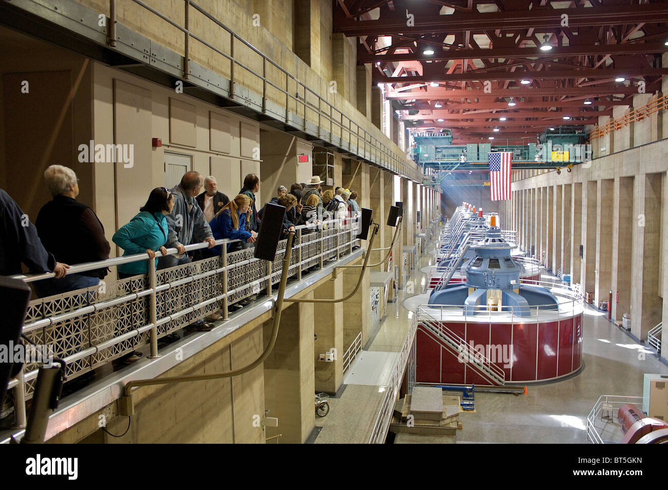 People on a guided tour of the Hoover dam look at the dam's power-generating turbines Stock Photo