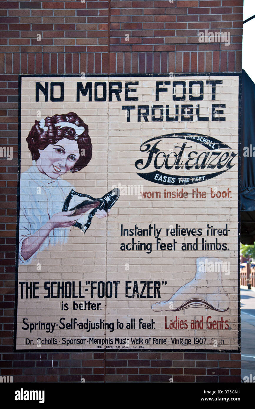 Vintage painted mural on a brick wall advertising the Scholl 'Foot eazer'. Beale Street, downtown Memphis, Tennessee, USA Stock Photo