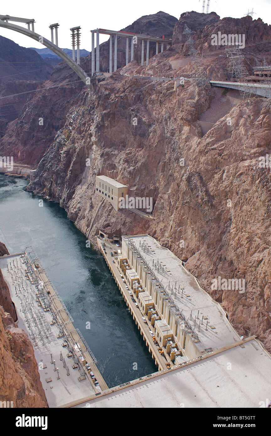 A view of the base of the Hoover Dam and the Hoover Dam Bypass under construction in the distance Stock Photo