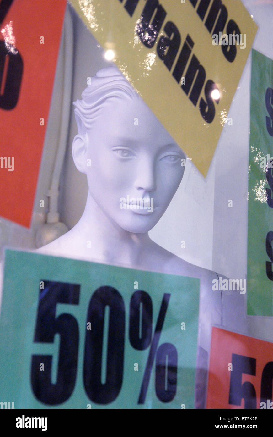 Female white mannequin head in window of shop with sale signs Stock Photo Alamy