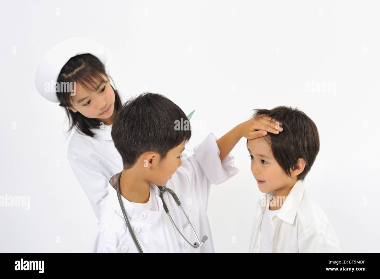 Children playing as doctor and nurse Stock Photo