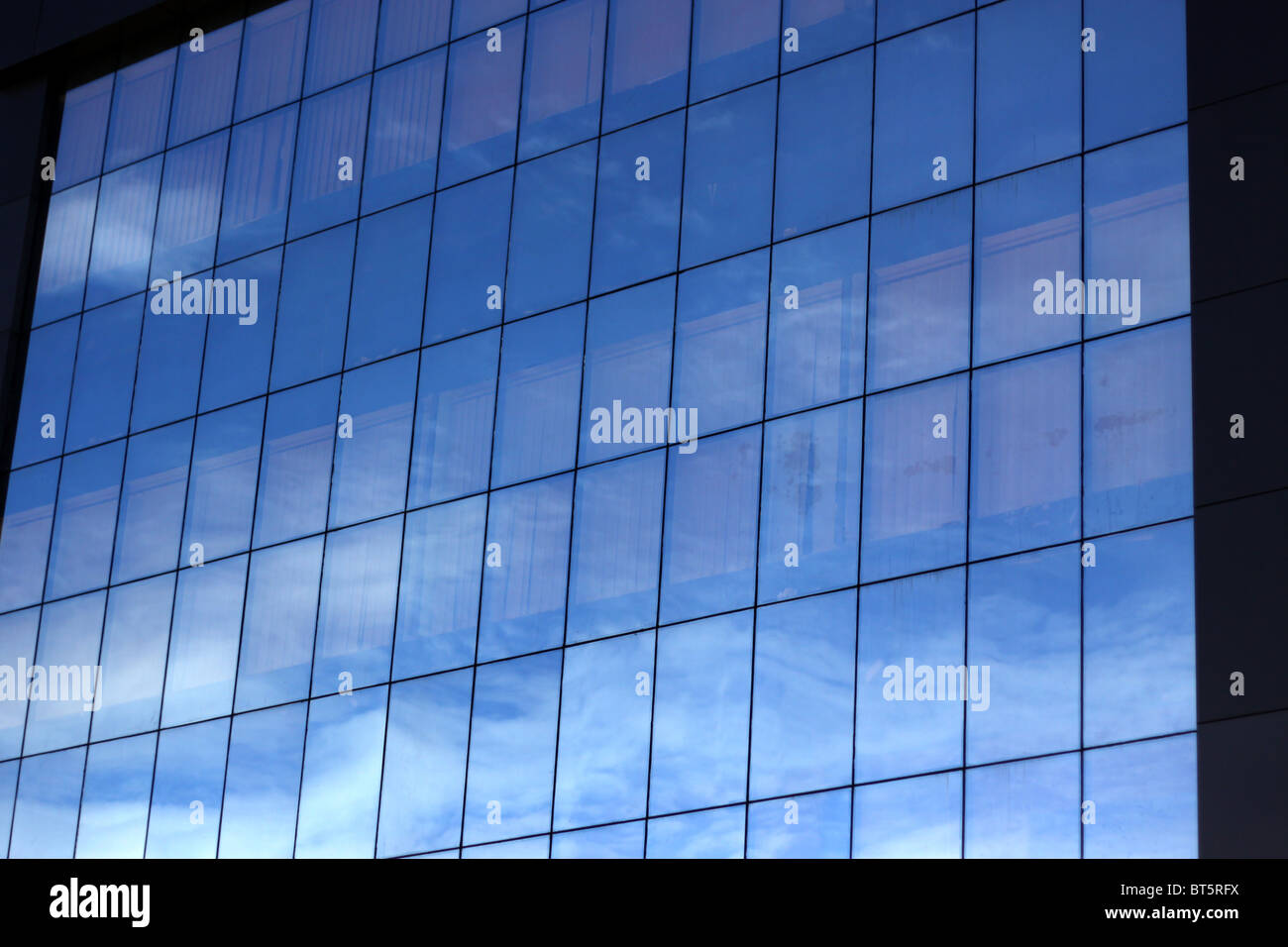 Office building with blue glass and reflection of sky Stock Photo - Alamy