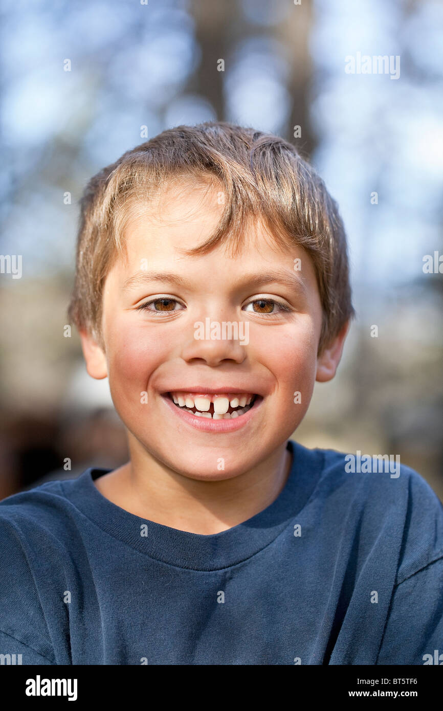 Close up of a smiling young boy, outdoors. Stock Photo