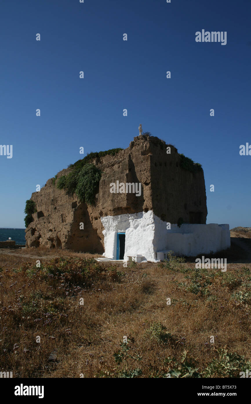 A small Greek chapel built from natural rock. The building sits on a cliff edge on the small Greek island of Skyros. Stock Photo