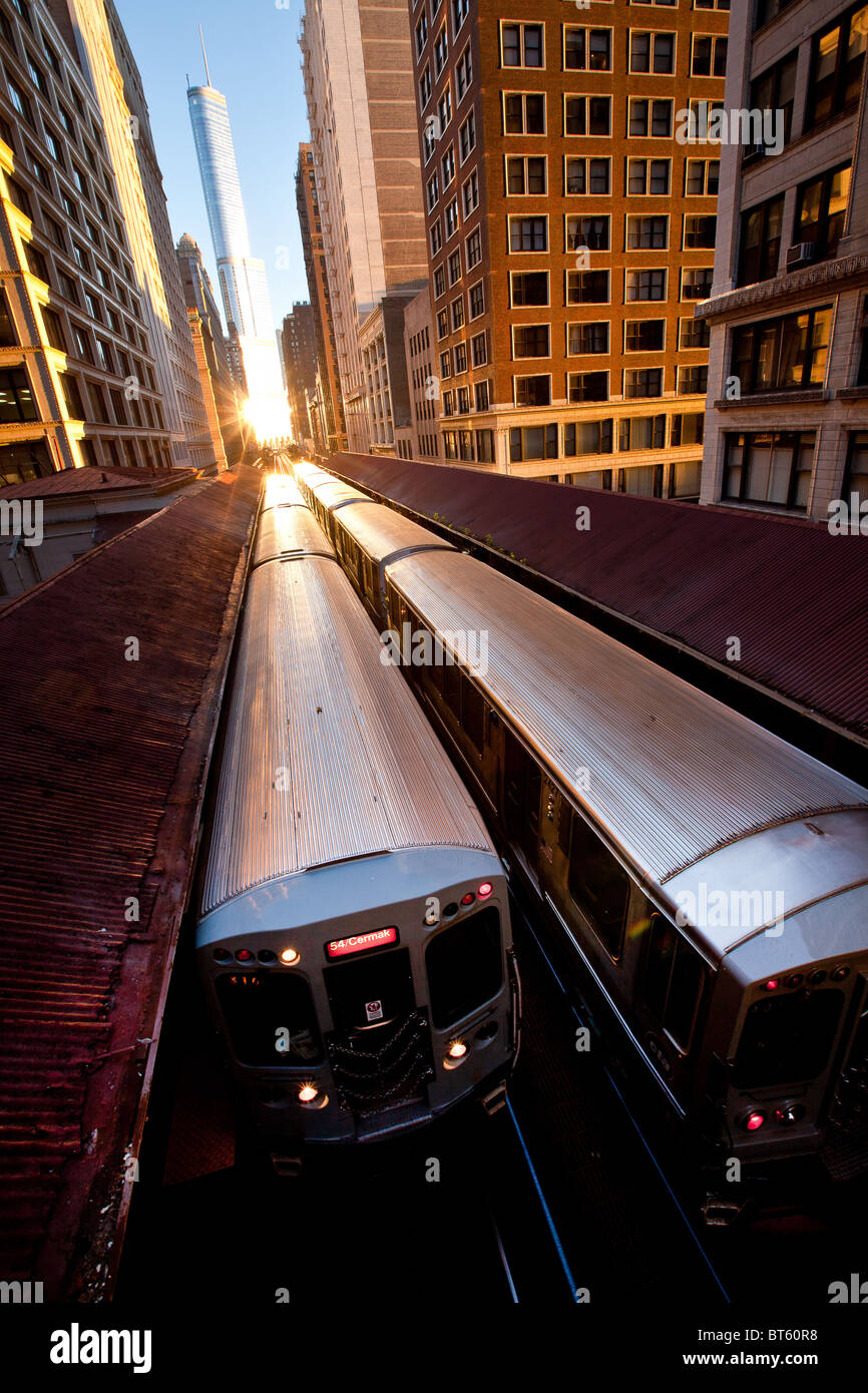 Sunrise illuminates a train in the Chicago rapid transit system known as the'L' in Chicago, IL, USA. Stock Photo