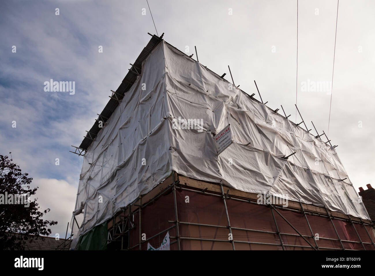 screened scaffolding on a small development Stock Photo