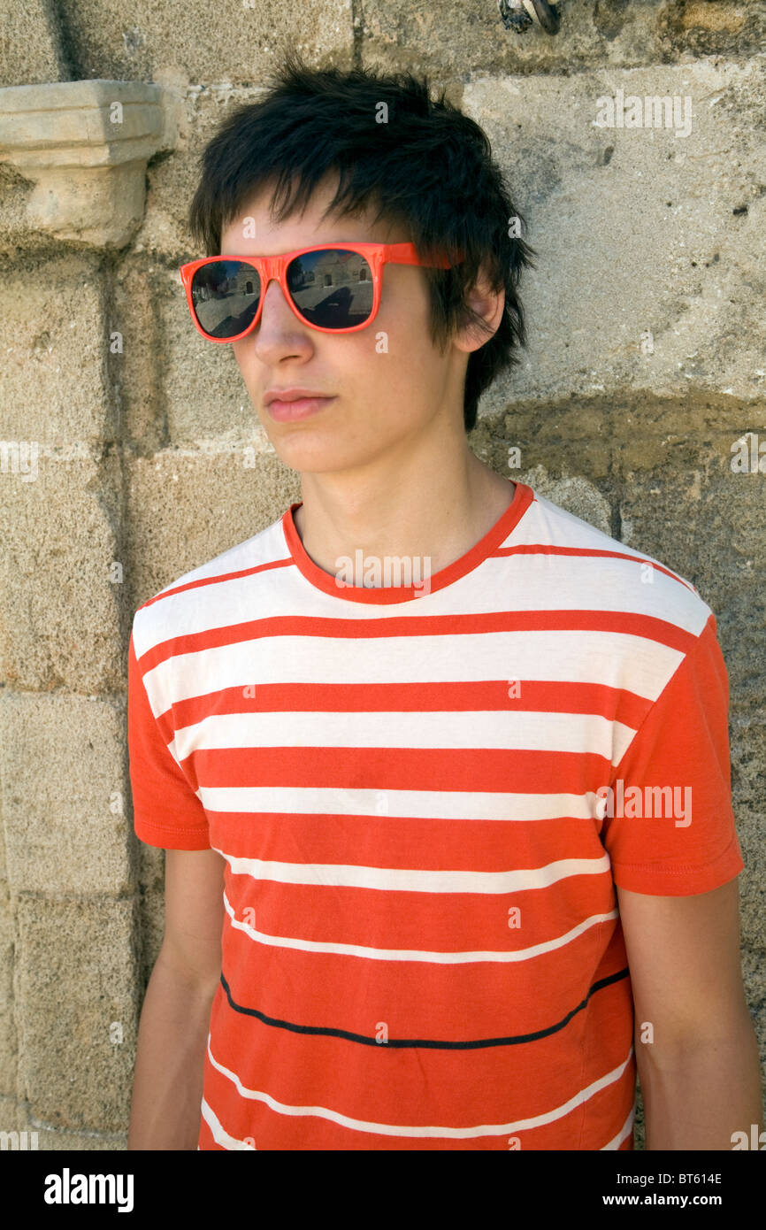 Teenage boy wears sunglasses orange striped T shirt Stock Photo Alamy