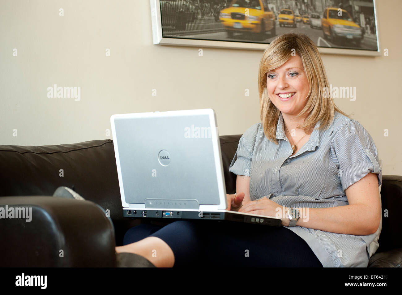 Pretty young woman using a laptop computer at home Stock Photo - Alamy
