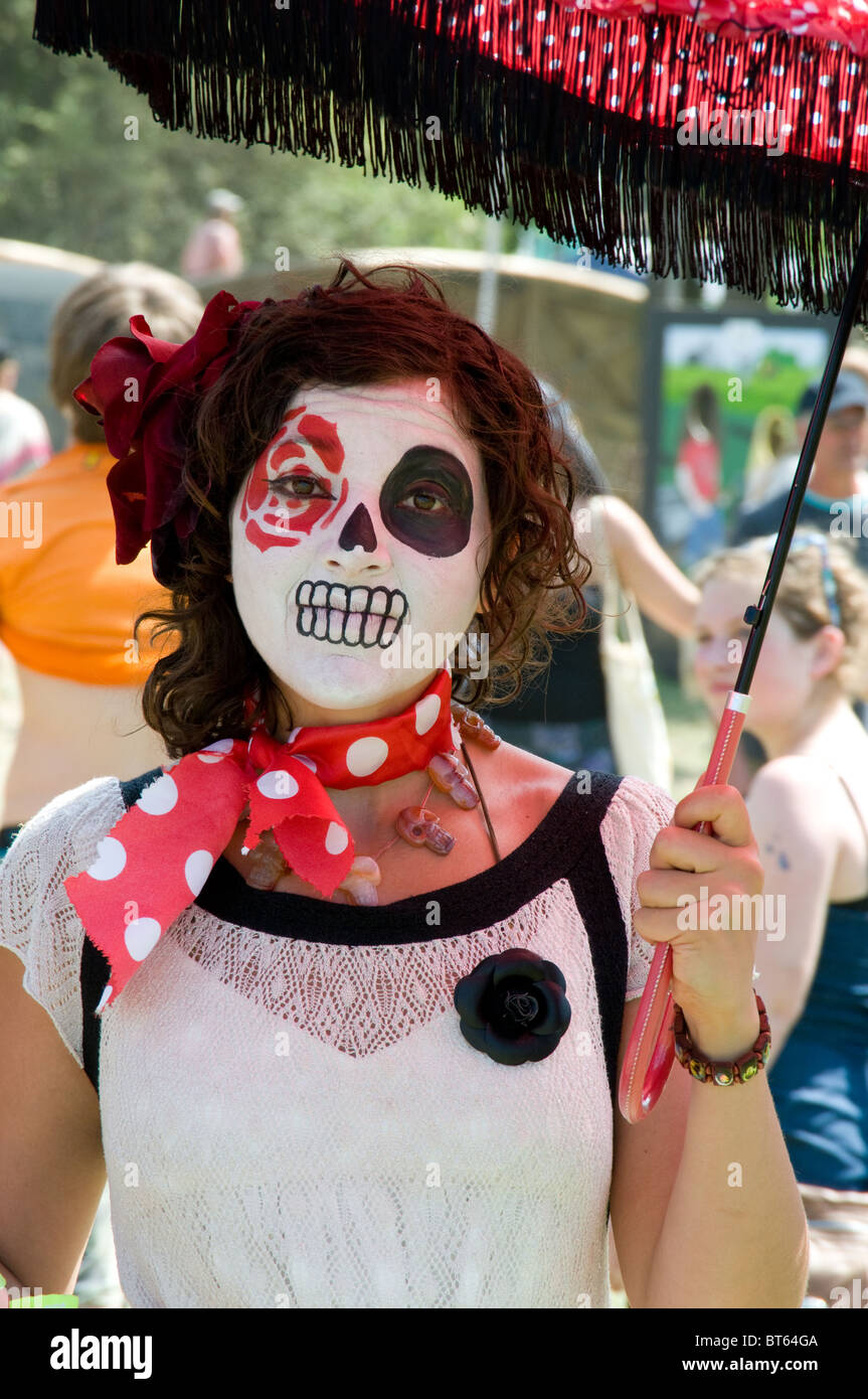 2010 Glastonbury Festival of Contemporary Performing Arts festival polka dot umbrella scull mask woman female girl white dress s Stock Photo