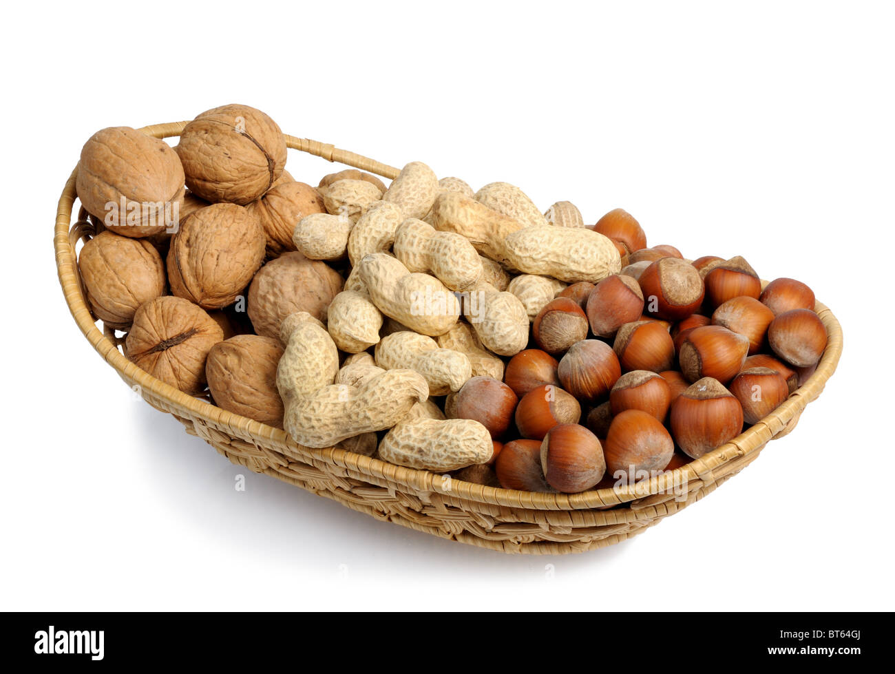Set of nuts in a wicker basket, isolation Stock Photo