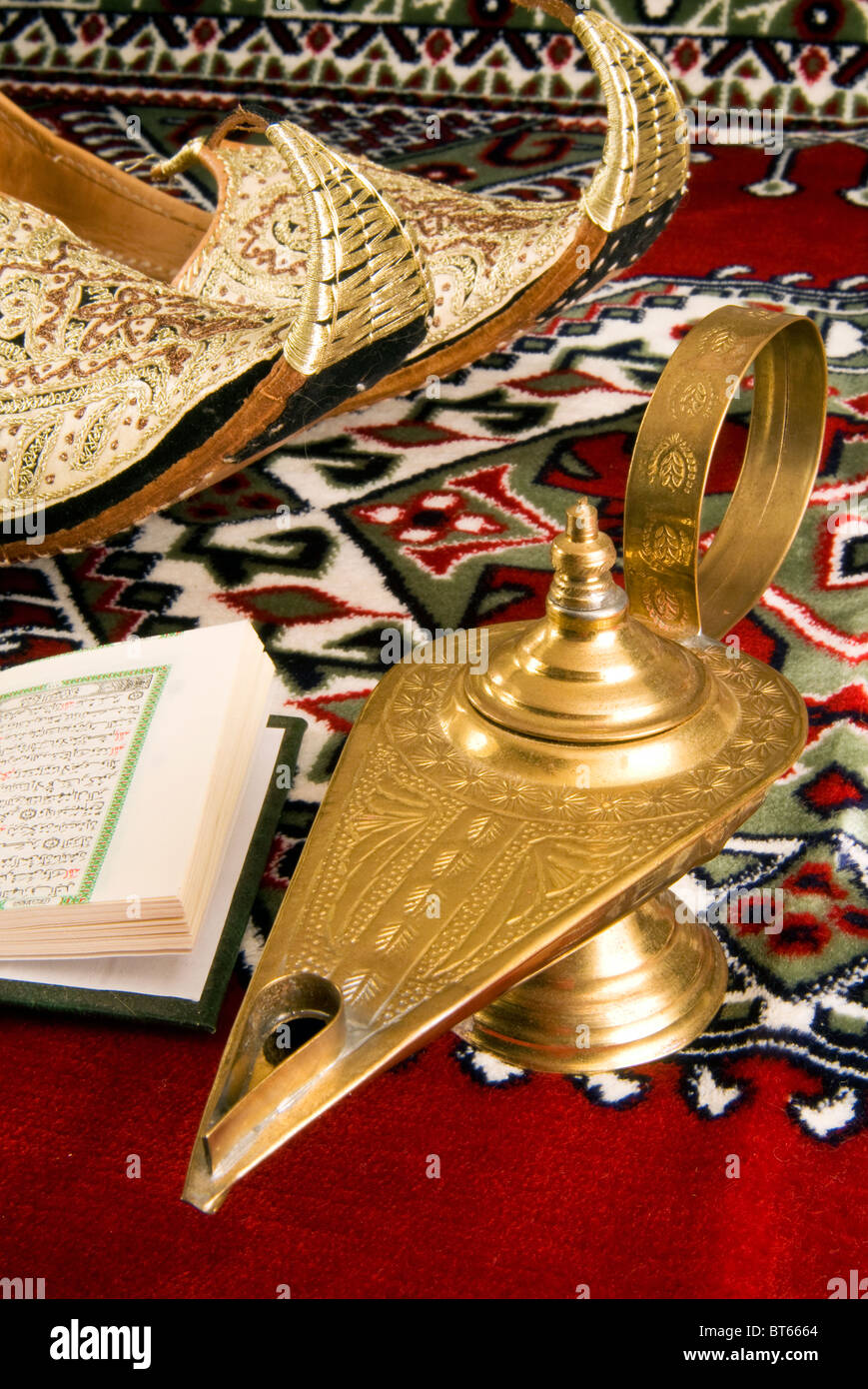Lamp of Aladdin, arabic shoes, quran on a carpet Stock Photo - Alamy