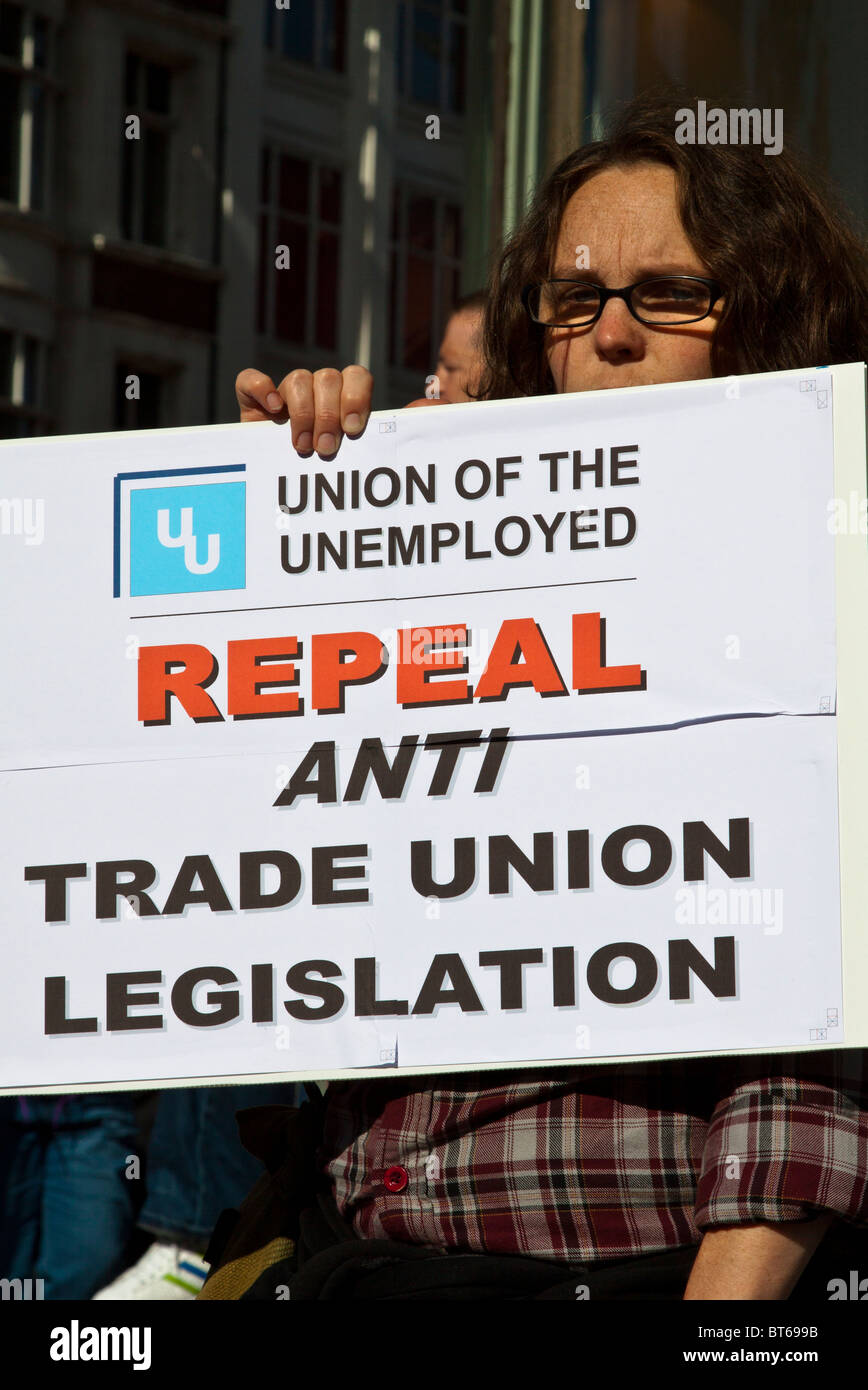 Man holding a placard asking that anti trade union legislation be repealed. Protesting against cuts, Belfast Stock Photo