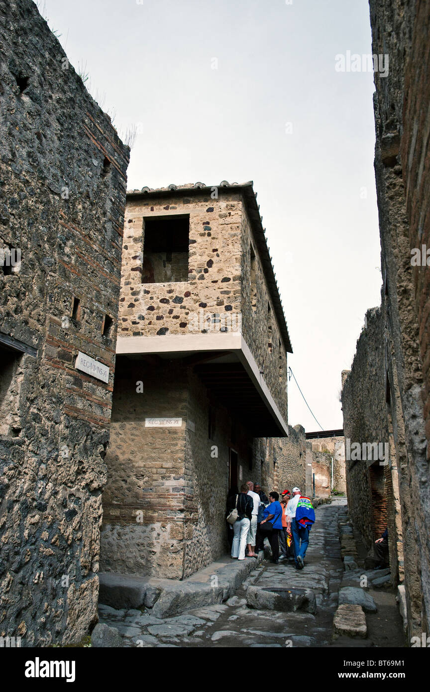 Tourists waiting to see the interior of an excavated Lupanar (Brothel), reputedly the largest in old Pompeii, Italy Stock Photo