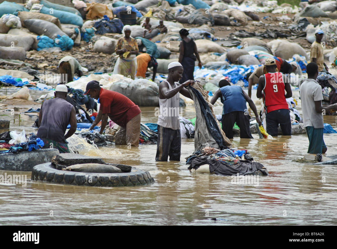 Men wash clothes in a muddy river, Abidjan, Ivory Coast Stock Photo Alamy