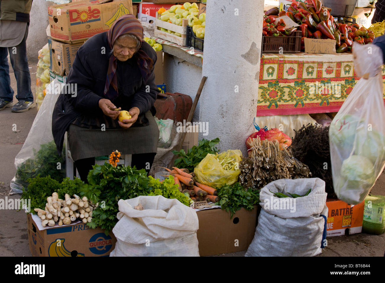 Stallholder with vegetables and herbs at Sigishoara fruit and