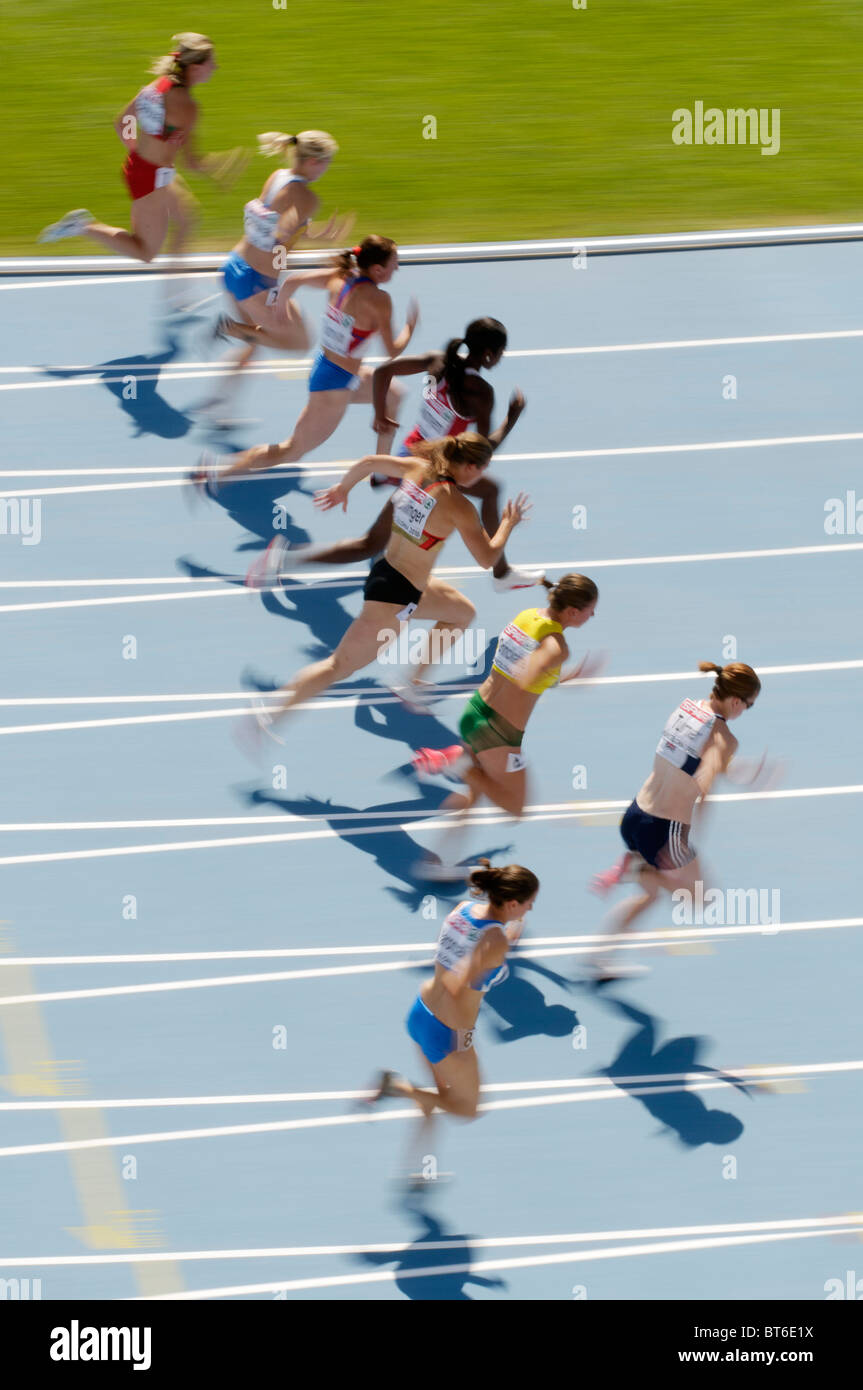 female sprinters running on blue track in womens race Stock Photo Alamy