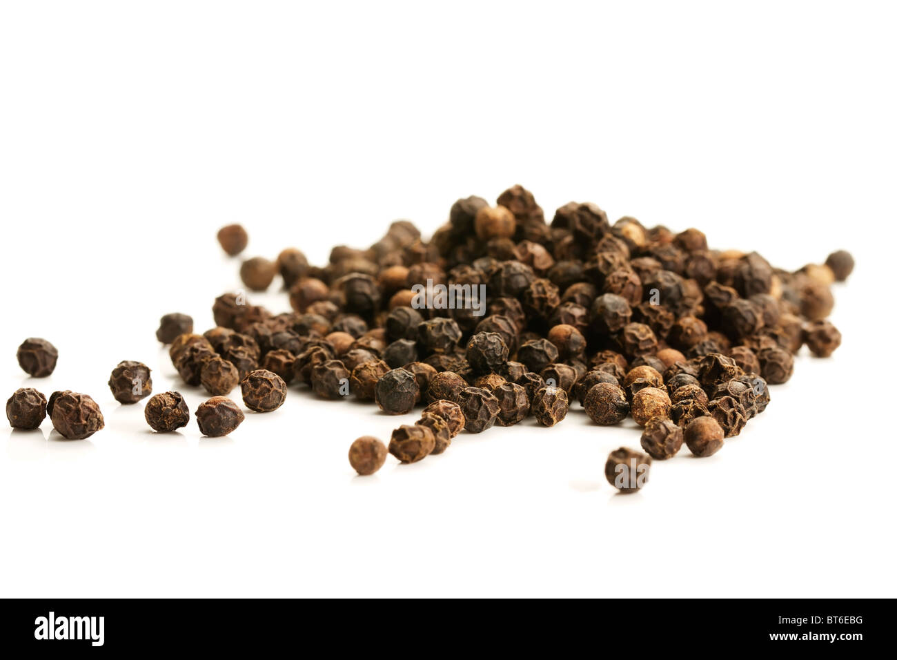 lot of black peppercorns on white background Stock Photo Alamy