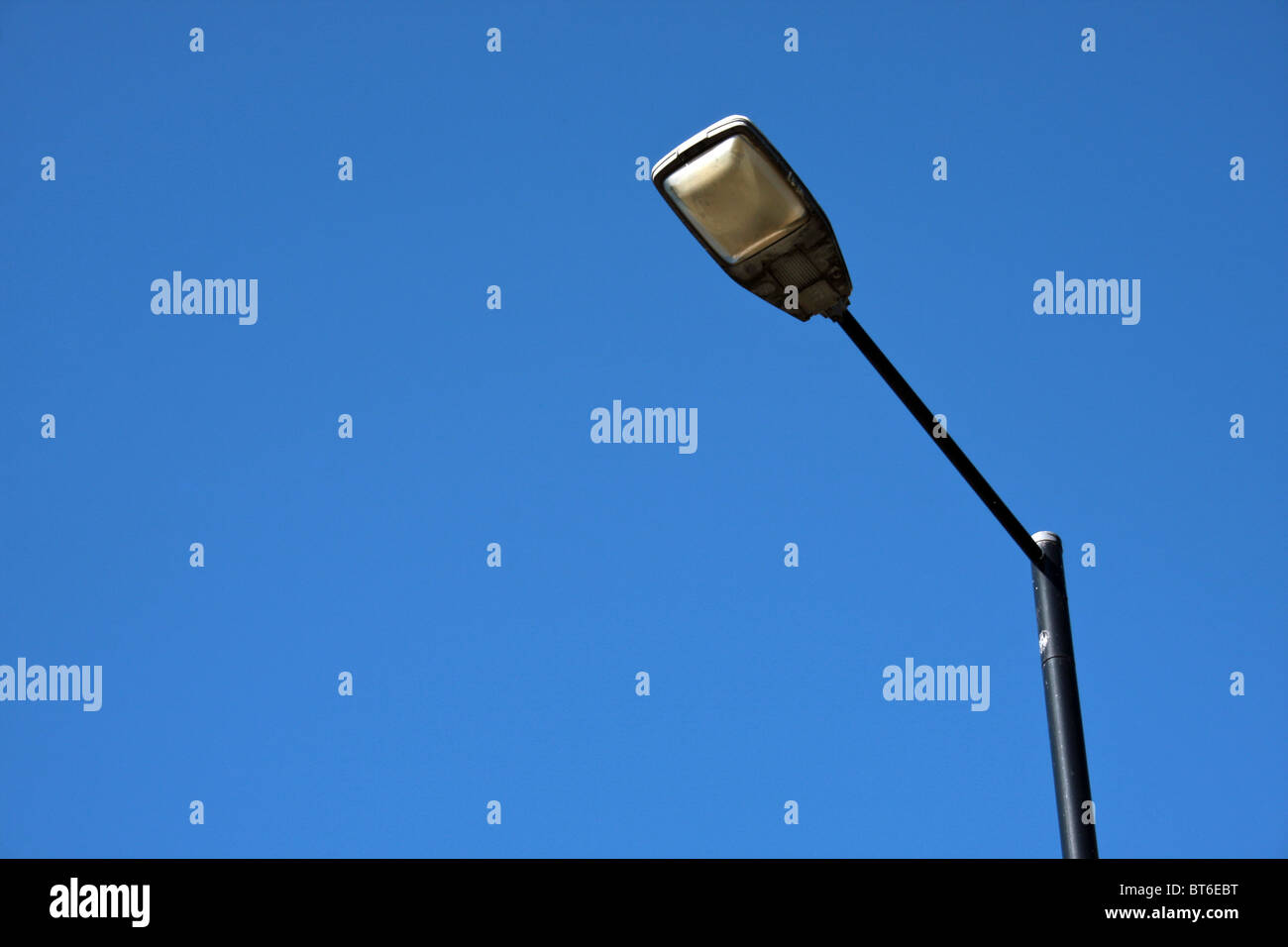 British street light, shot from below, against a deep blue sky Stock