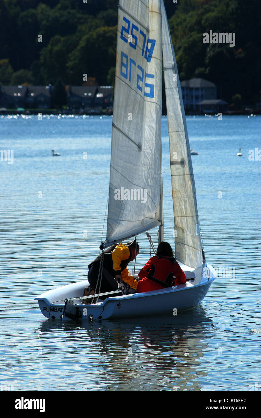 Young couple prepare to sail. Stock Photo