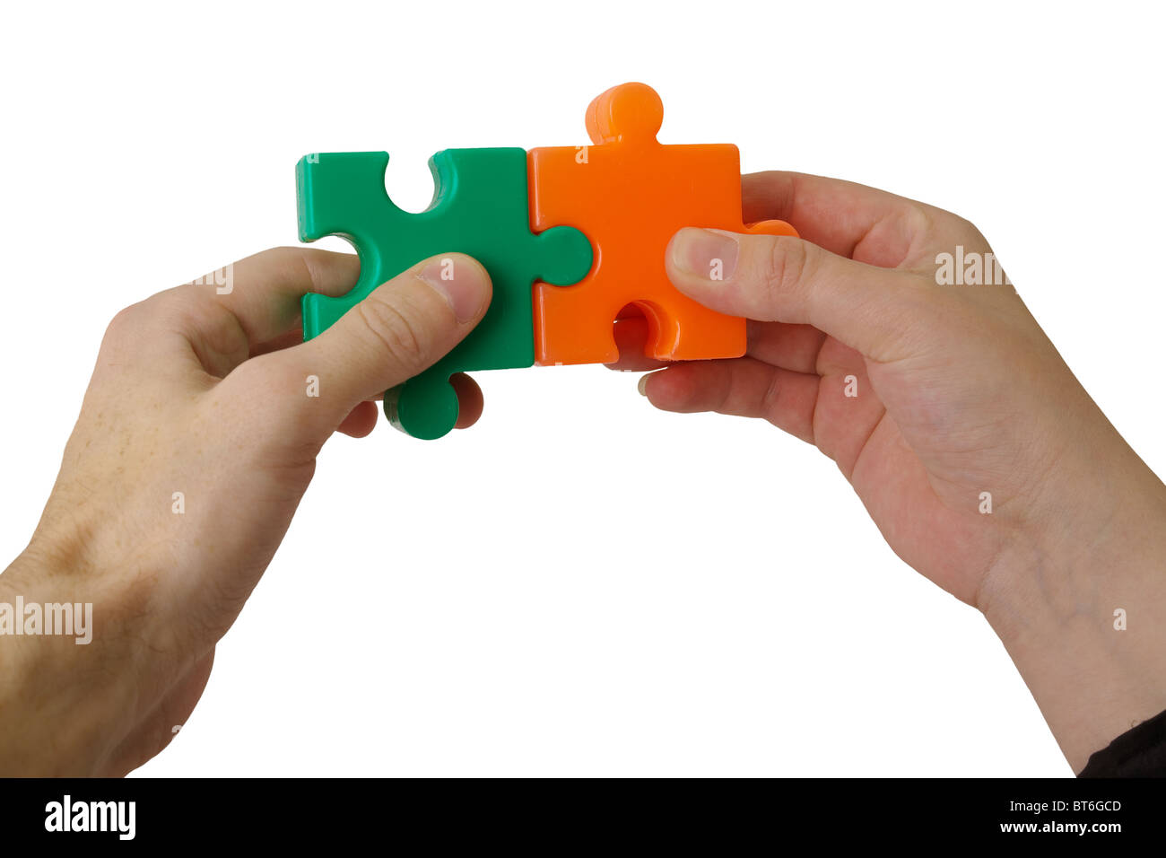 Hands holding details of a puzzle on a white background Stock Photo