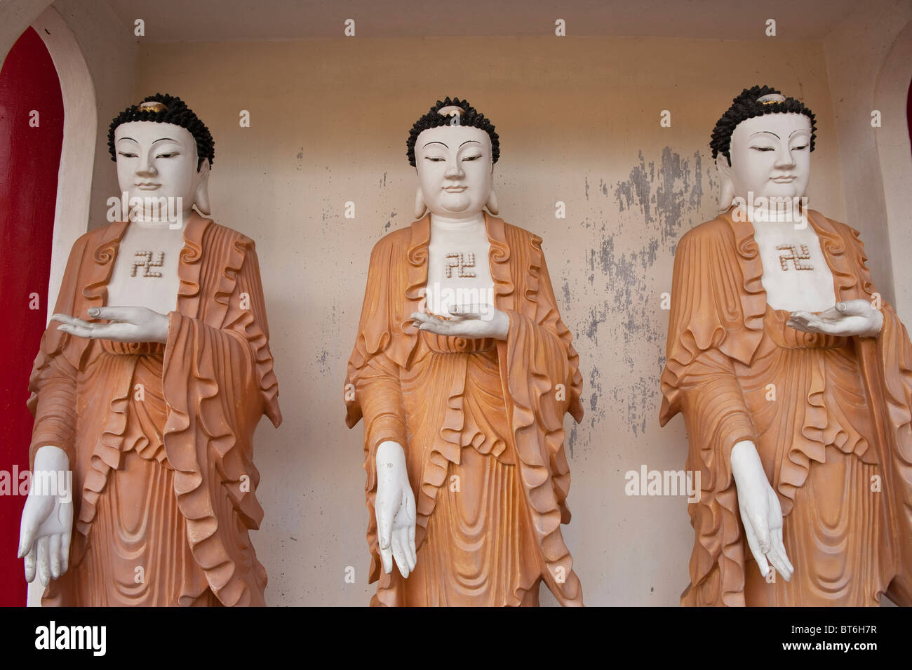Statues of Buddha displaying Buddhist Swastikas on the chest in Kek Lok