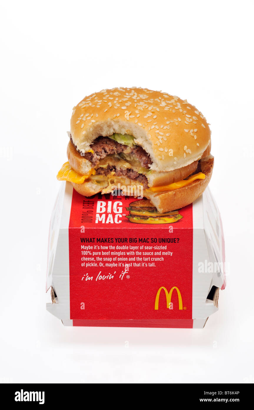McDonald's Big Mac on top of box with bite out of it on white background cut out. Stock Photo