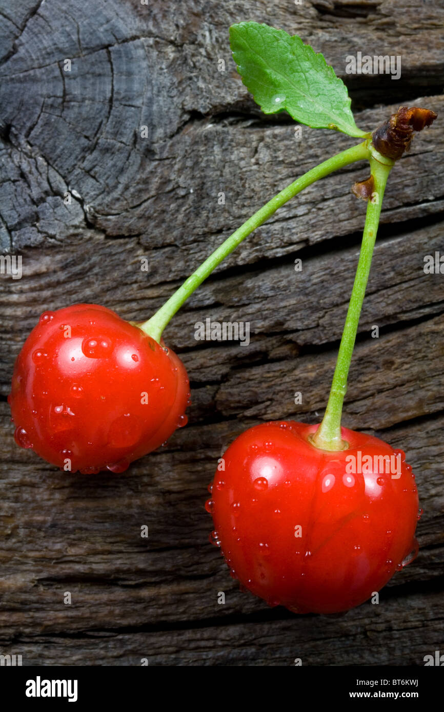 Red Ripe Cherries on Weathered Wood Stock Photo