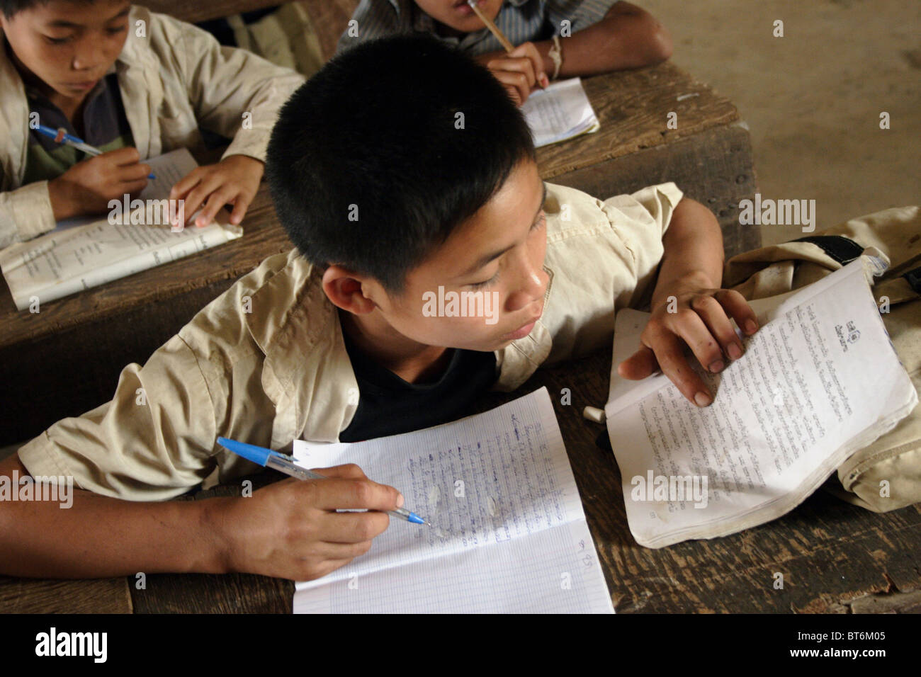 A 10 Year Old Boy Is Sitting At A Desk Studying Language At A