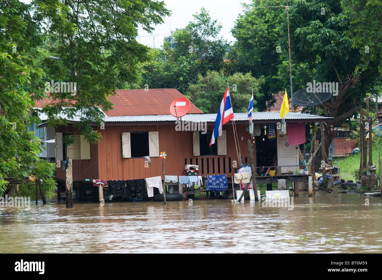 House on stilts during monsoon season in Thailand, with water