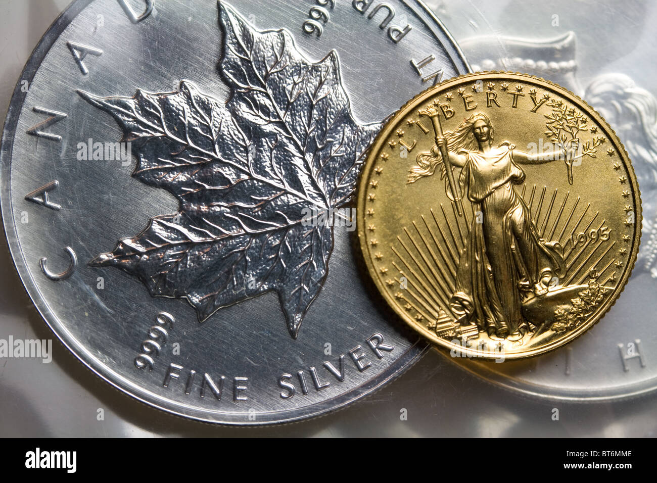 Canadian Maple Leaf Silver Bullion Coin - United States Gold Eagle Bullion Coin Stock Photo