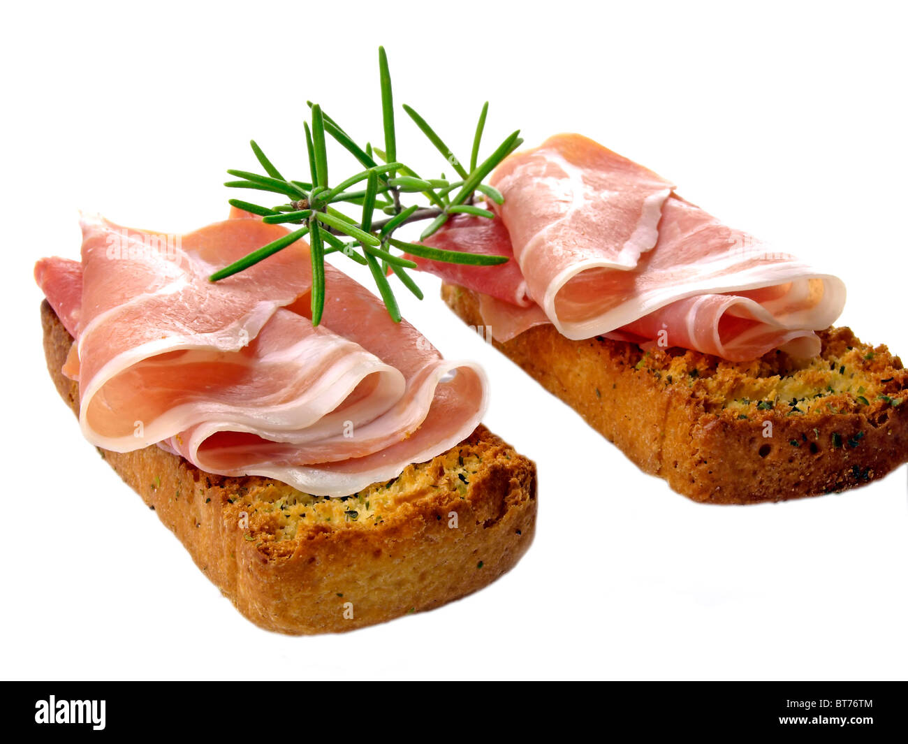 ham of Italy on a bruschetta bread with rosemary Stock Photo