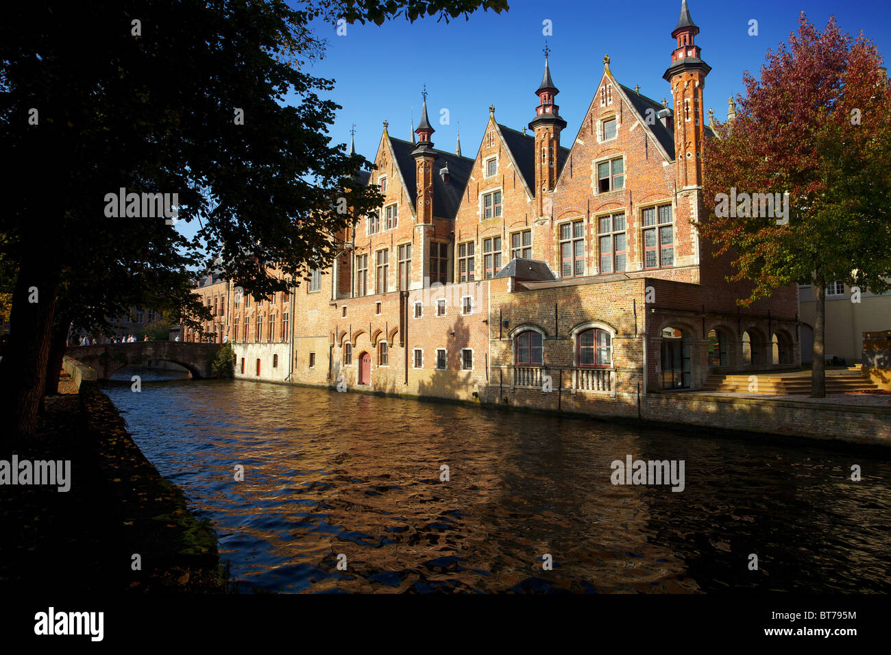 Old restored buildings on a canal in Bruges Stock Photo