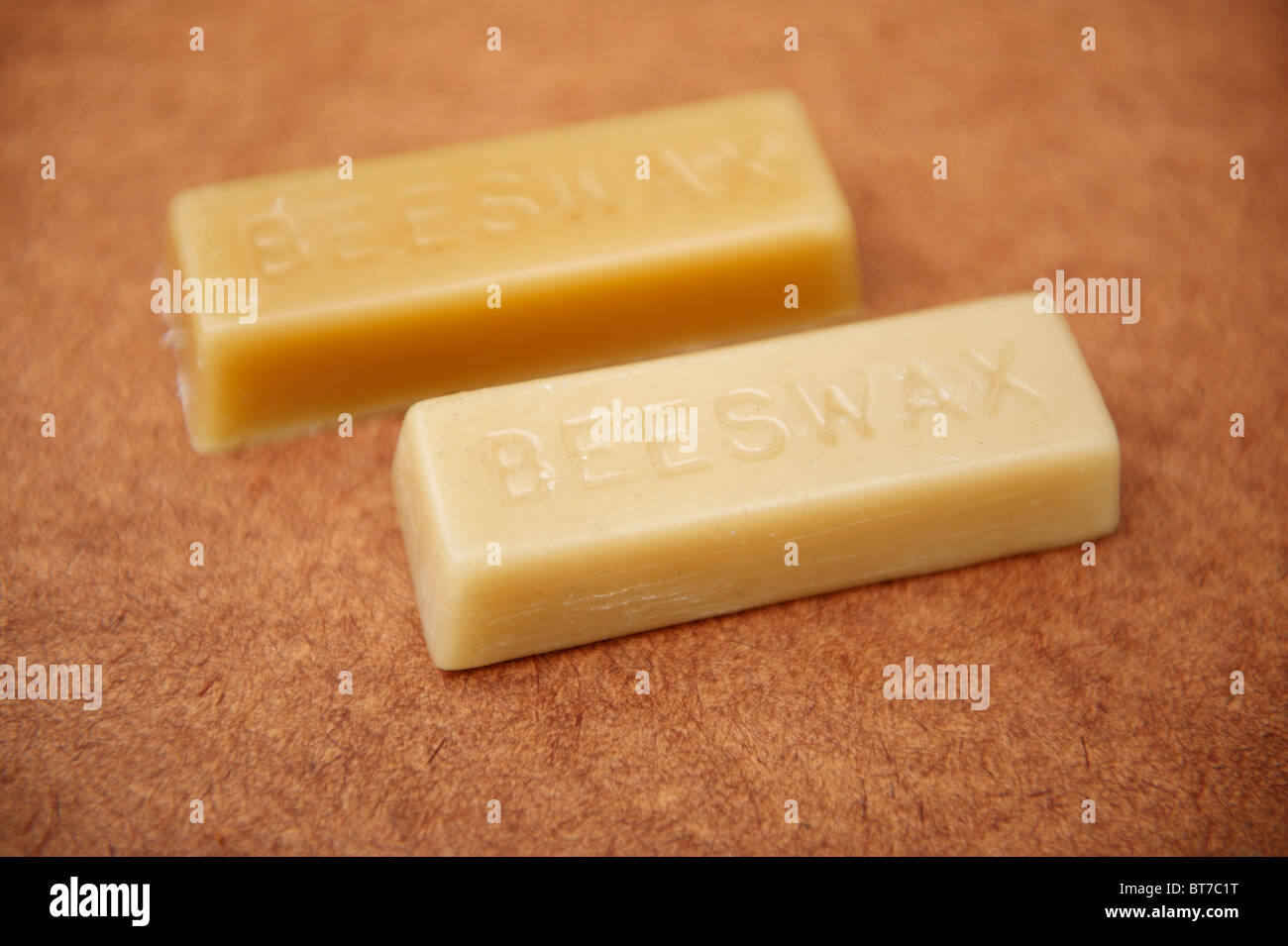 2 blocks of beeswax on a piece of wood Stock Photo Alamy
