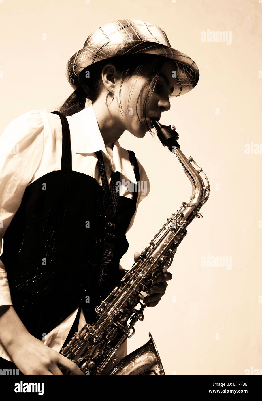 Girl playing the saxophone Stock Photo