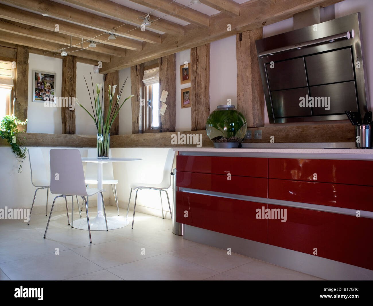 Modern white circular pedestal table with white chairs in country