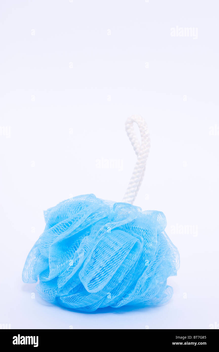 A close up photo of a blue bath scrunchie for washing against a white background Stock Photo