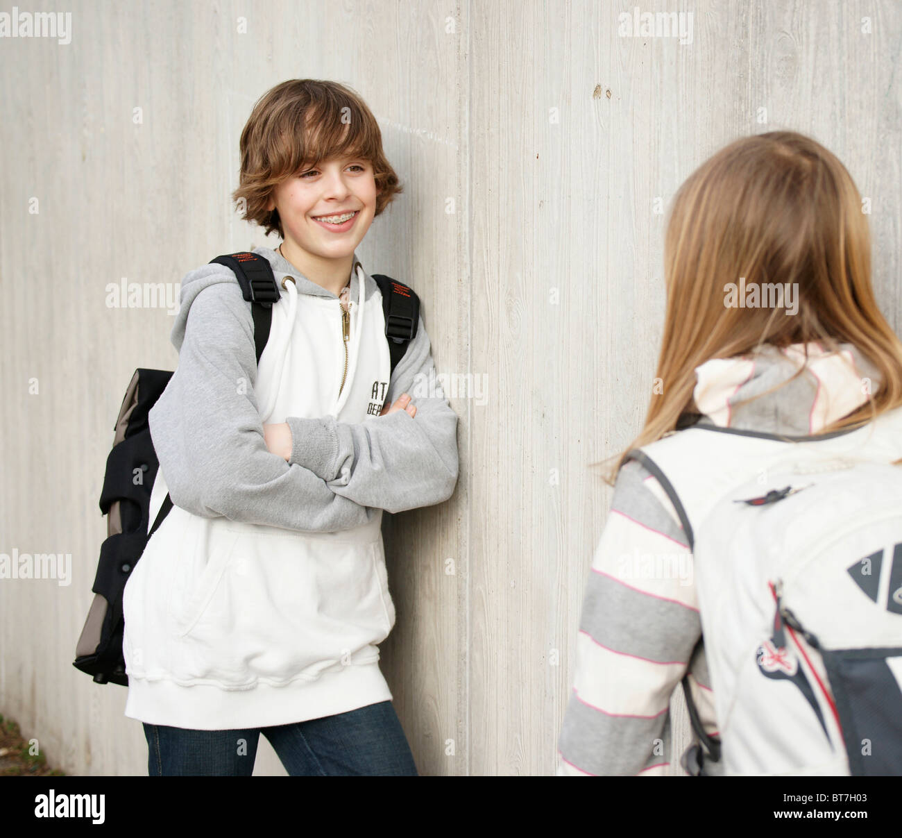 Boy and a girl talking in the schoolyard Stock Photo - Alamy