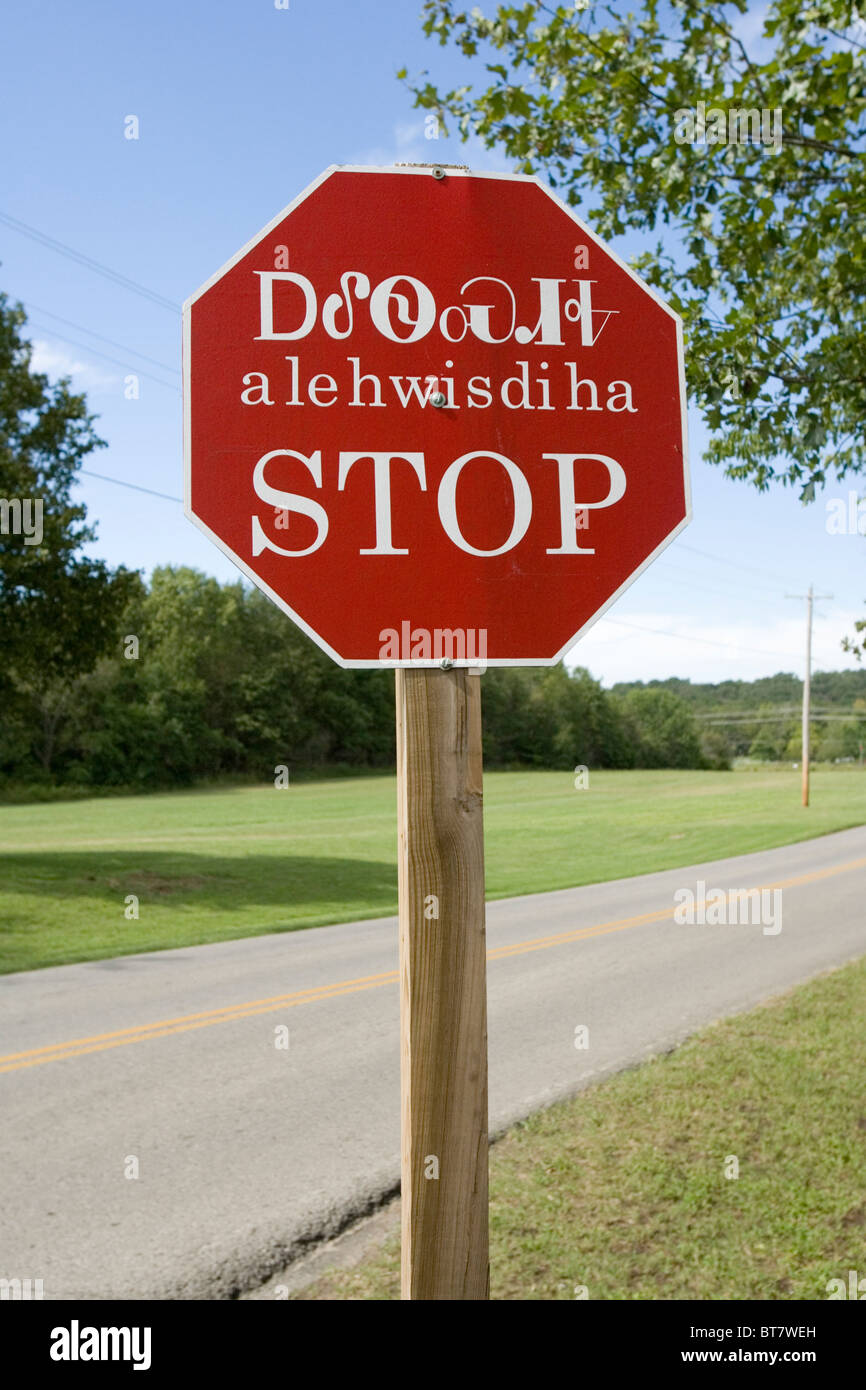 Not your ordinary Stop sign! This signis on the grounds of the Cherokee National Museum in Tahlequah, Oklahoma. Stock Photo