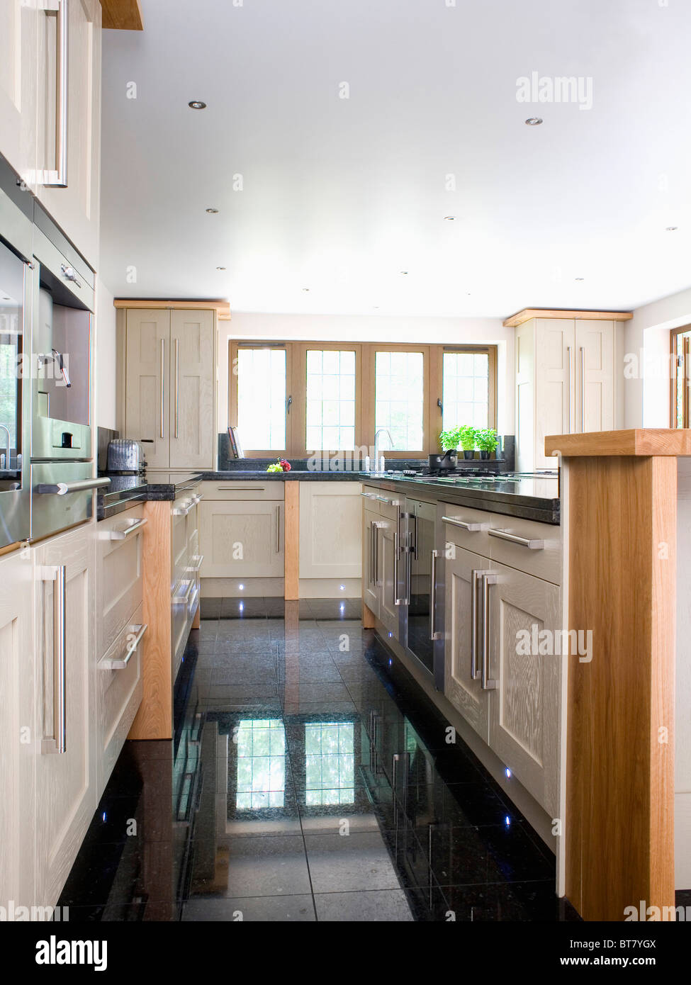 Black granite flooring in large modern kitchen extension Stock ...