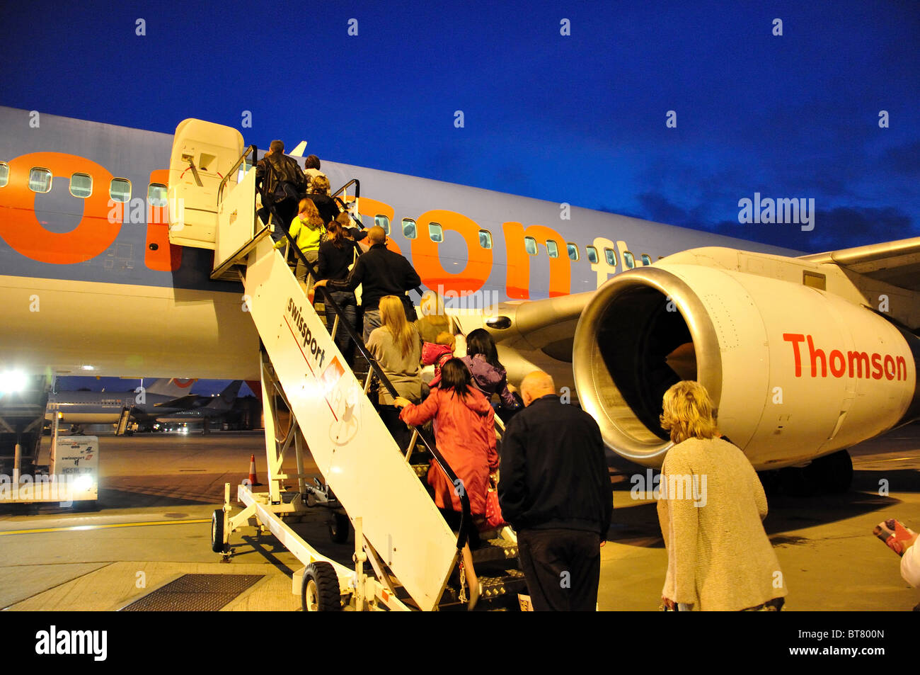 Passengers boarding Thomson Boeing 757-200 aircraft, Gatwick Airport, Crawley, West Sussex, England, United Kingdom Stock Photo