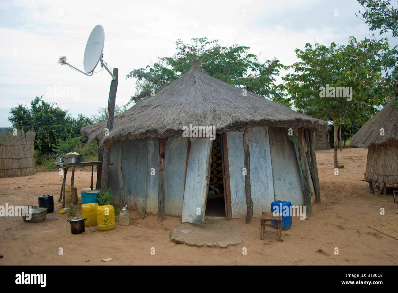 A typical African hut with satellite dish in Zambia. Stock Photo