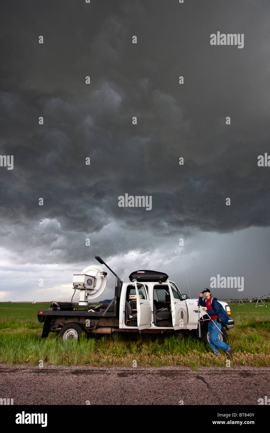 Storm chaser and scientist Robin Tanamachi stands next to a doppler radar truck that she is operating for Project Vortex 2 Stock Photo