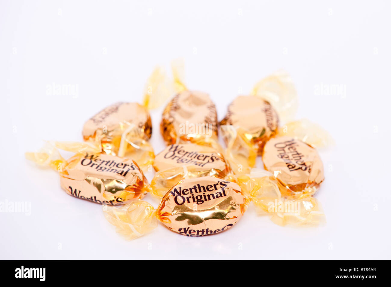 A close up photo of some Werthers Original butter candies sweets against a white background Stock Photo