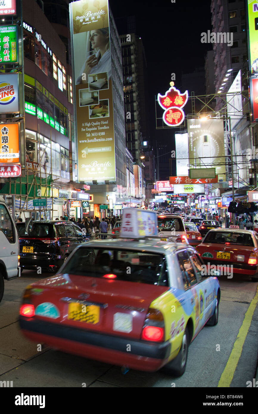 Famous street in Kowloon, Nathan Road, Hong Kong, massive lit shop signs light the way for shoppers Stock Photo