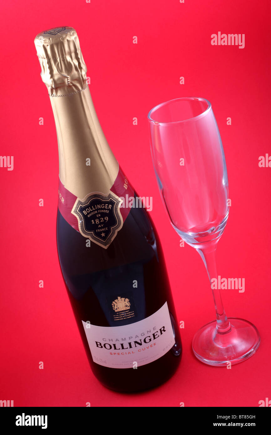 Bottle of Bollinger Special Cuvee Champagne with a single champagne flute. Stock Photo