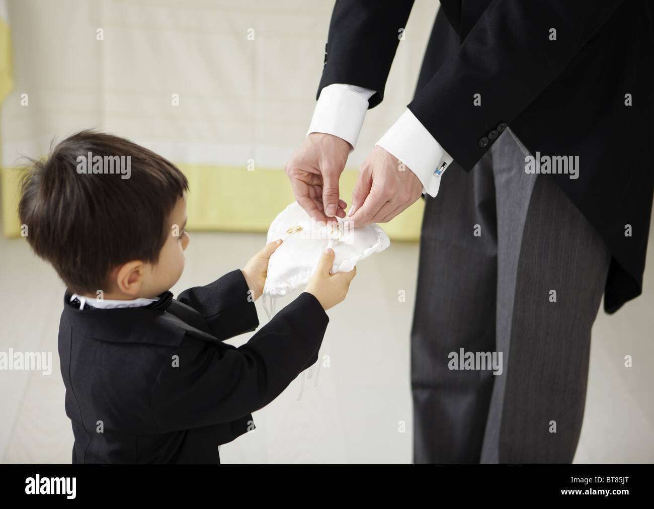 Boy holding out a ring pillow Stock Photo - Alamy