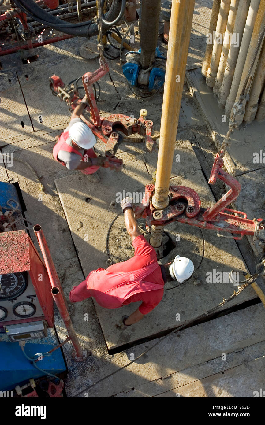 Onshore oil and gas exploration rig site. Looking down on crewmen