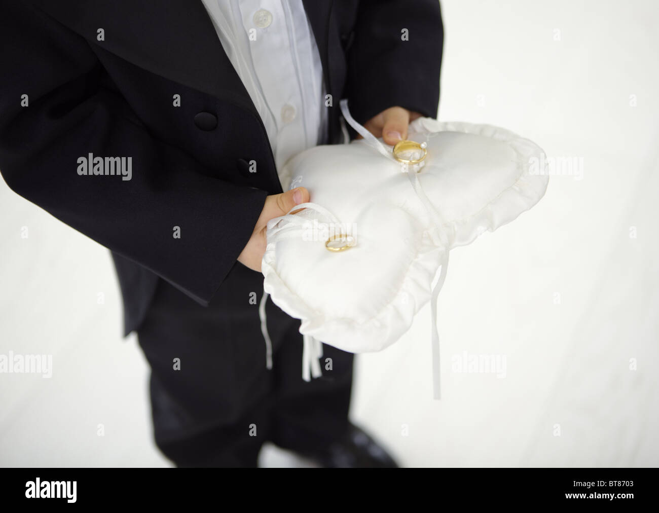 Boy holding a ring pillow Stock Photo Alamy