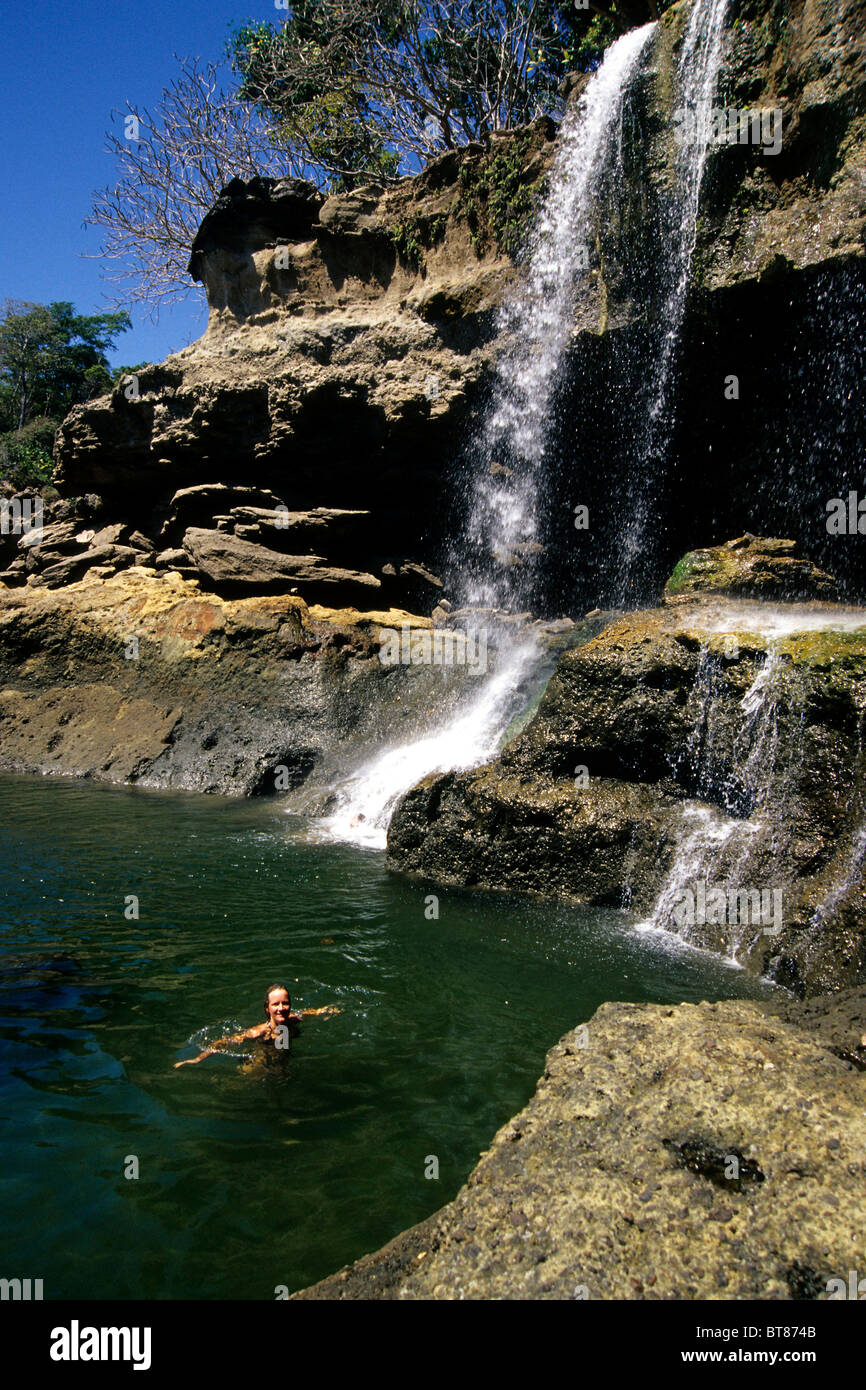 Waterfall with swimming woman near Montezuma, Peninsula de Nicoya, Costa Rica, Pacific Ocean, Central America Stock Photo