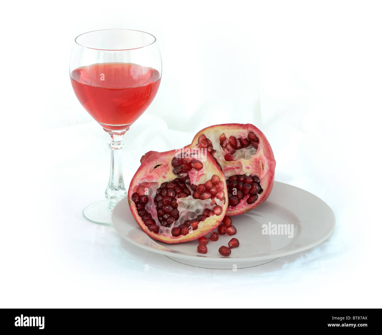 Still-life with a glass of wine and a red pomegranate Stock Photo - Alamy